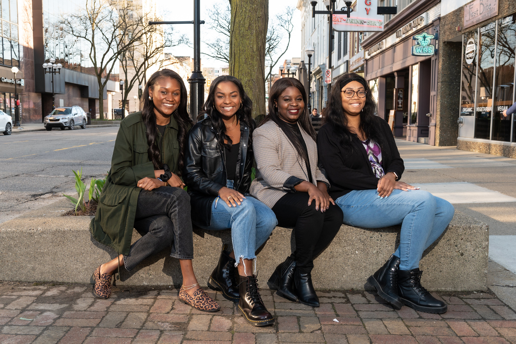 Four black women from team Real Execs of Ross, posed outside.