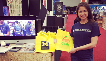 Stacey Matlen in the U-M booth at SXSW in Austin, TX