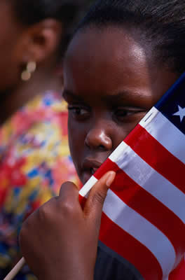 young black girl holding an American flag