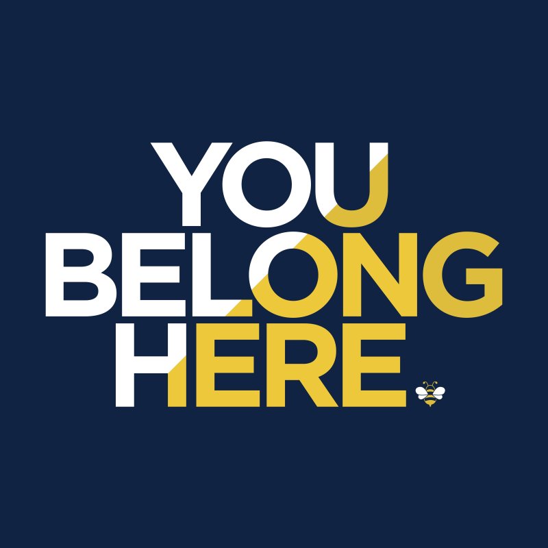 Navy blue background with white and yellow text that says You Belong Here with a small bee graphic as a period