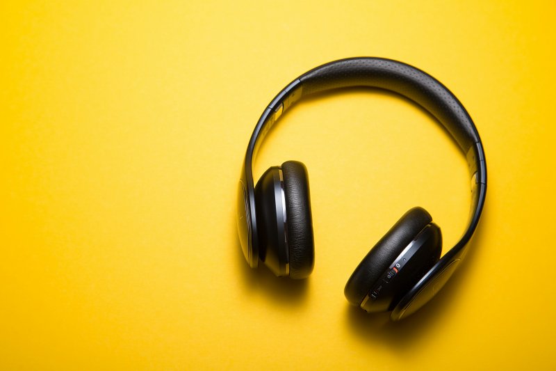 Pair of headphones with a yellow background