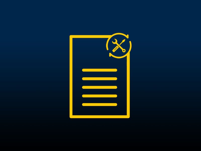 A screwdriver and wrench over a lined document