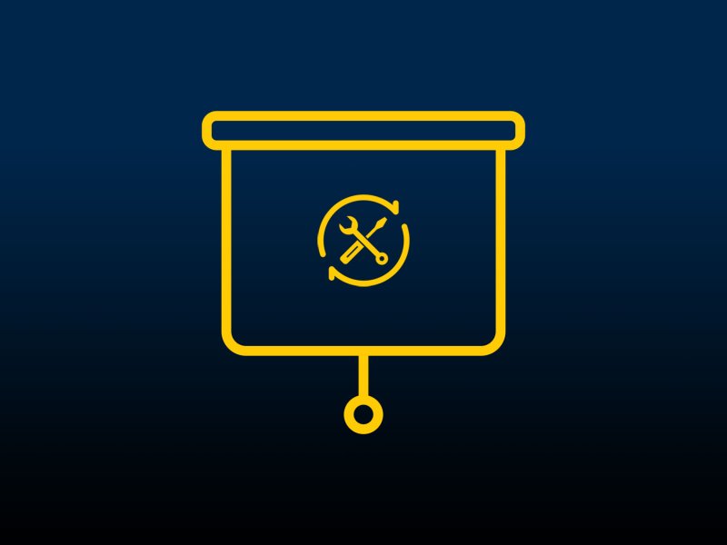 A screwdriver and wrench over a pull-down projector screen