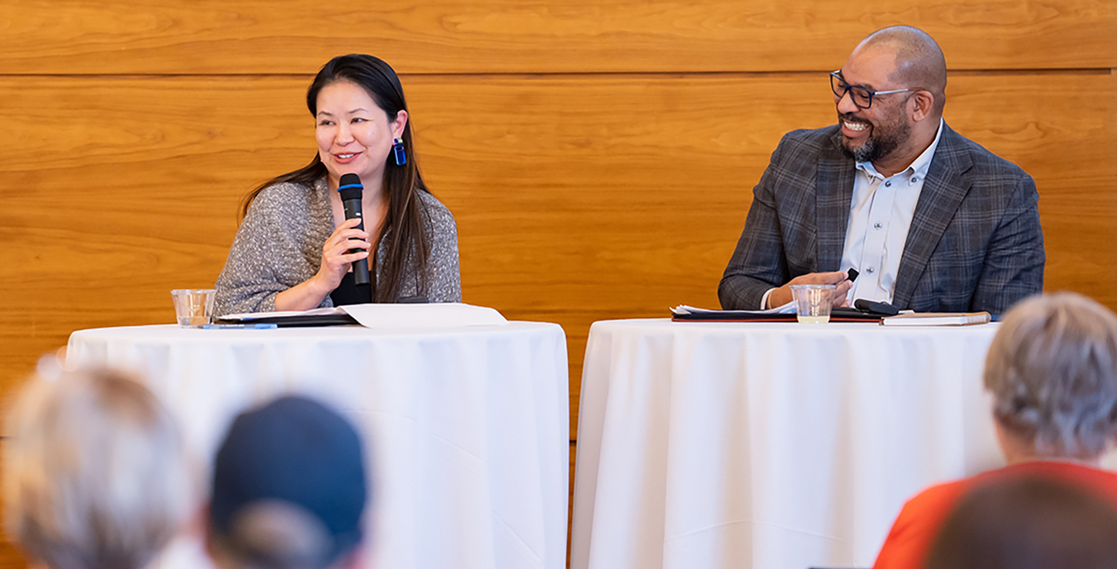 Asian Woman and Black man presenting in an auditorium.
