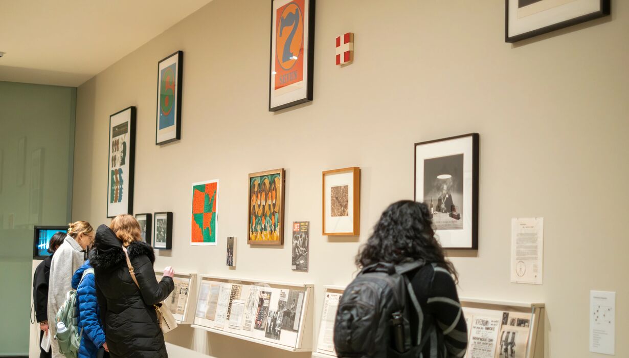 Photo of students looking at art
