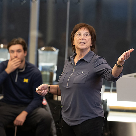 Sue Ann Savas presenting in front of young man