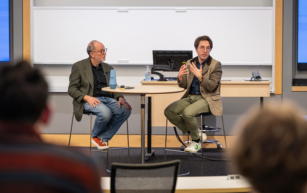 Xavier Blott with Jerry Davis at an event with an audience