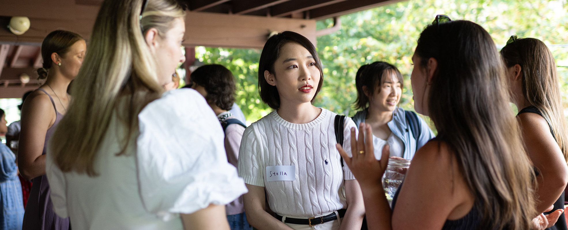 Asian woman white woman and latina speaking at a gathering at Dominicks