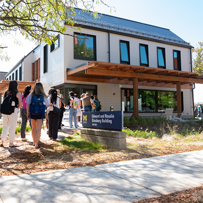 2026 Ginsberg Center building with diverse group of students entering the front door, their backs to us