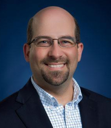 Josh Botkin portrait in front of blue background