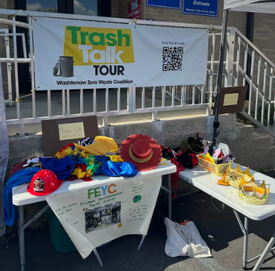 Table with various costume items from the Trash Talk Tour event