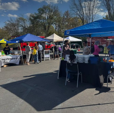 People gathered at tents for a thrifting event