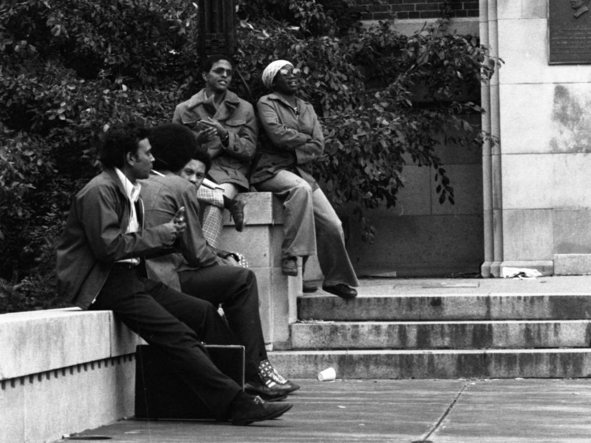 African American students sitting outside a building in the 1970's during the Black Action Movement