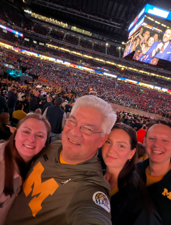 Savas family in a selfie at a night football game